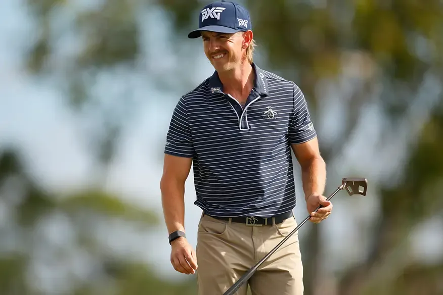Jake Knapp in a PXG cap and striped polo, holding his Scotty Cameron Phantom mallet putter.