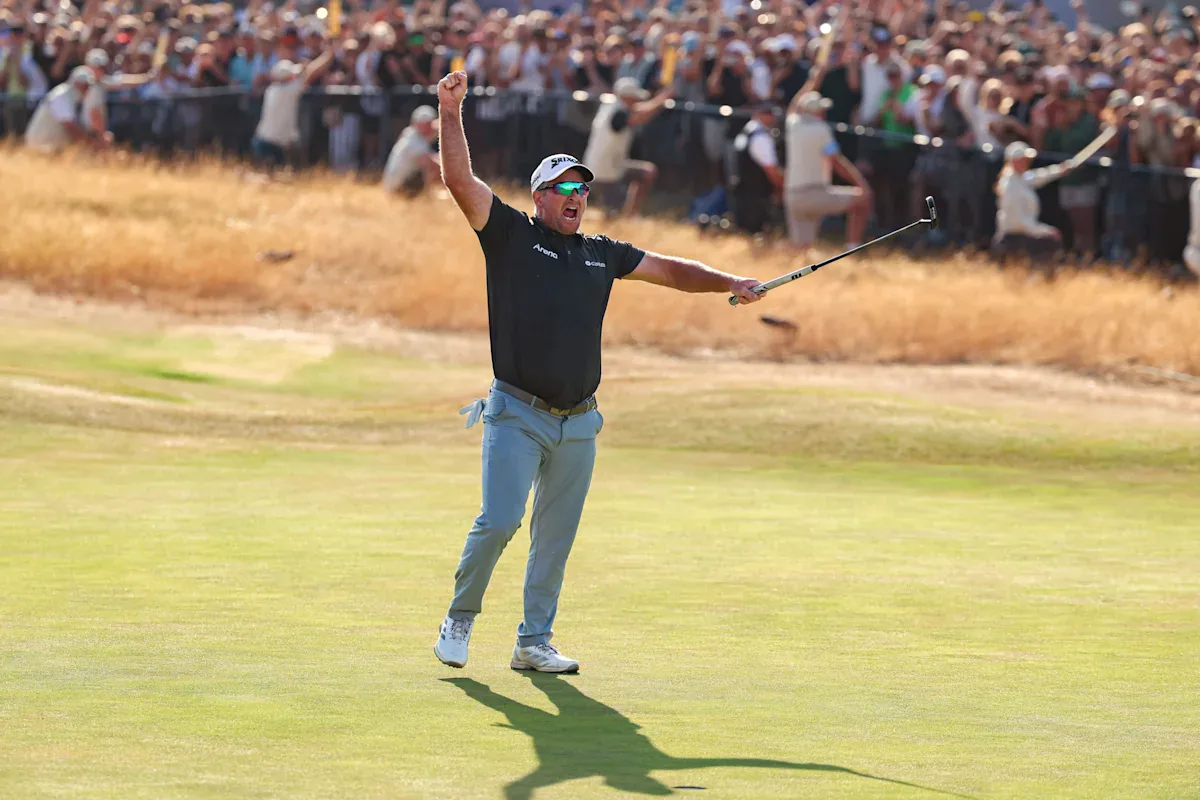 Ryan Fox celebrating with both arms raised after holing the winning putt at Royal Birkdale