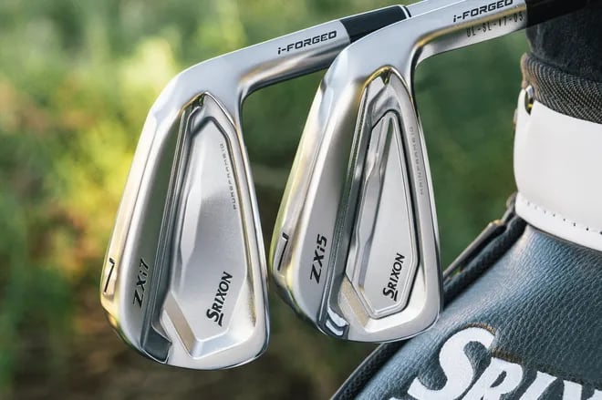 Srixon ZXi7 and ZXi5 7-irons side by side in front of a Srixon staff bag